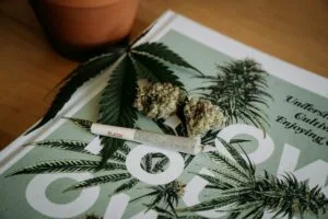 cannabis pre rolls laying on top of magazine on table