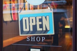 Glass door of a shop with a blue Open sign